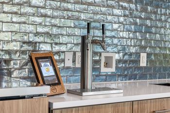 a kitchen sink with a tablet on the counter